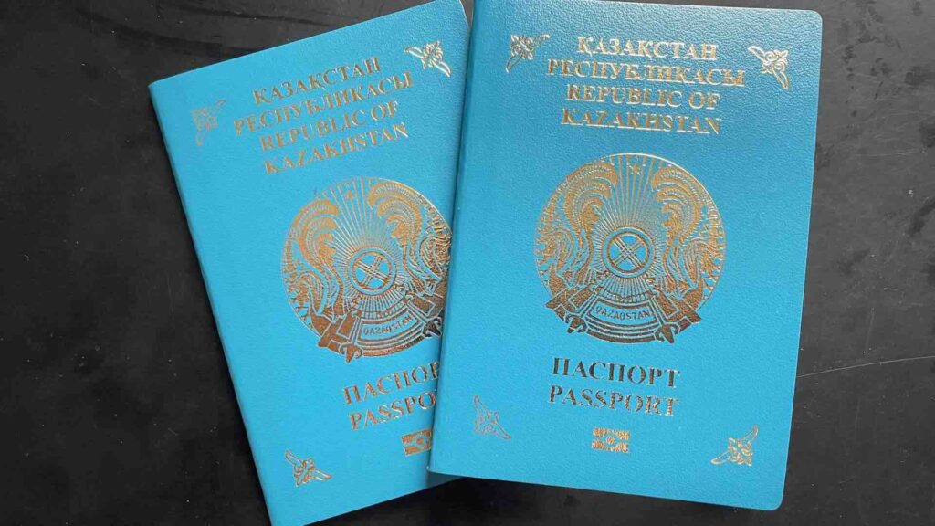 Казахстанский паспорт лежит на темном фоне