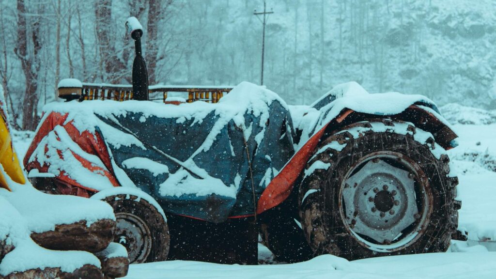 Трактор под снегом в горах Алматы