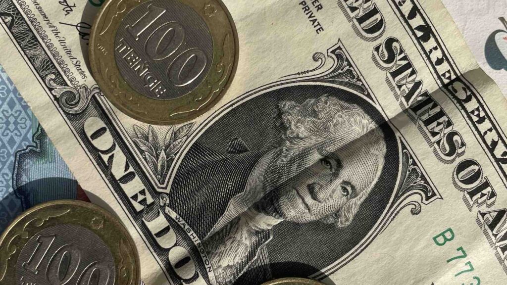 Монеты тенге на долларе США