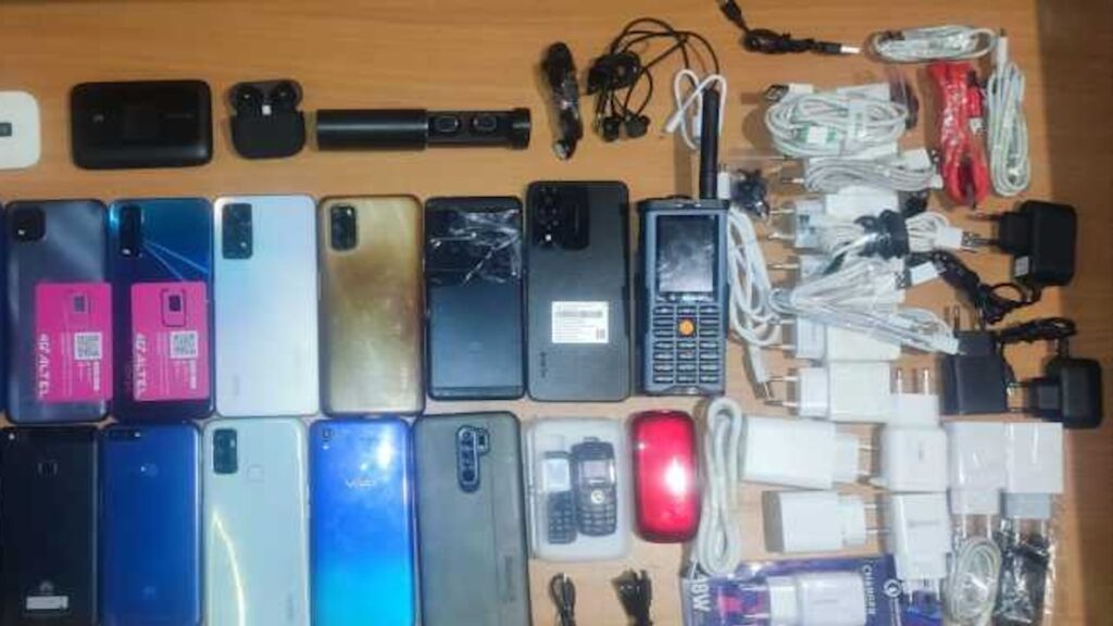 На столе телефоны и зарядные устройства, которые пытались провезти в тюрьму